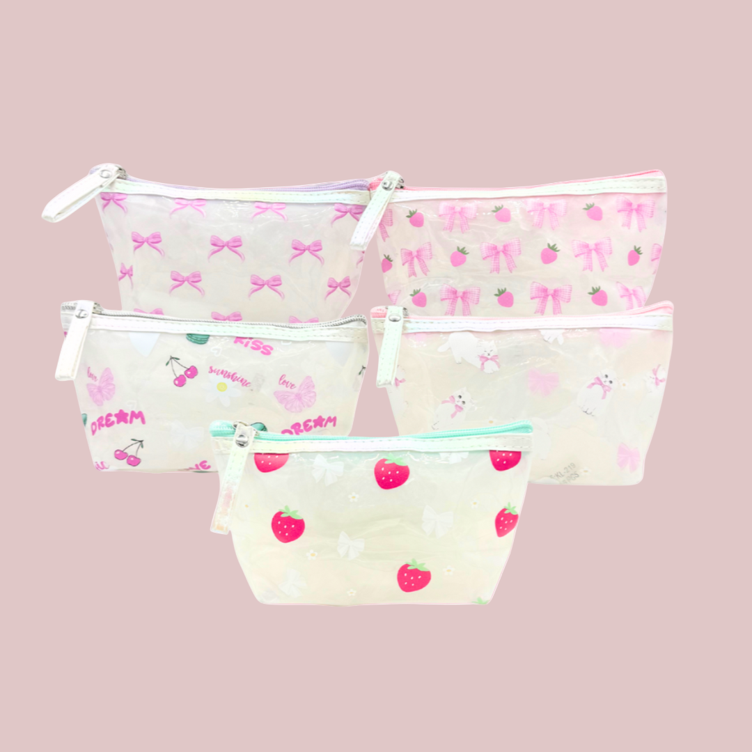 Set of three clear pouches with printed designs on a pink background