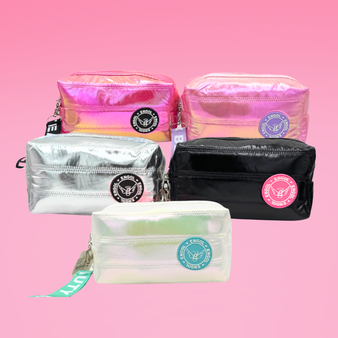 Set of colorful makeup bags on a pink background
