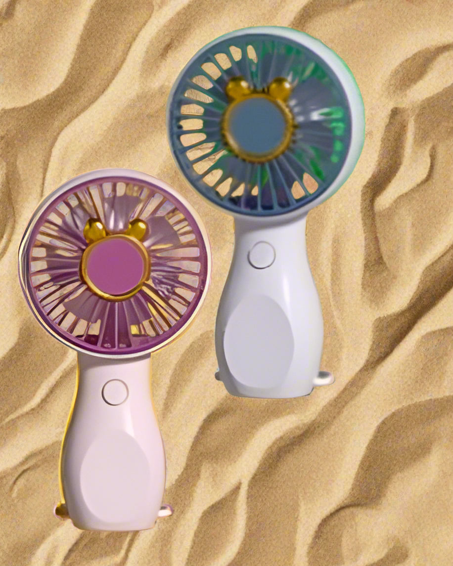 Two handheld fans with purple and yellow designs on a beach background