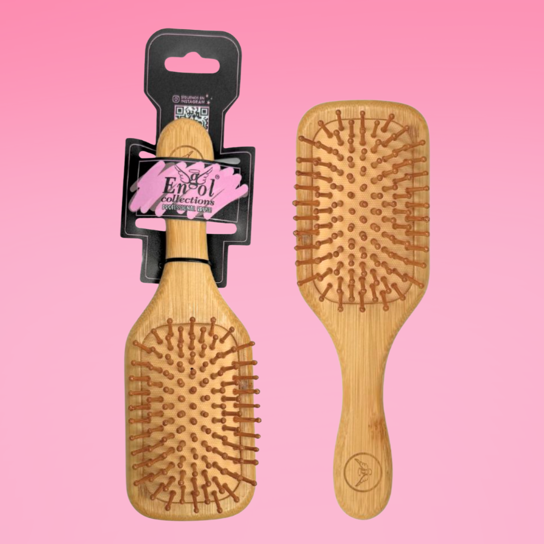 Wooden hairbrushes on a pink background