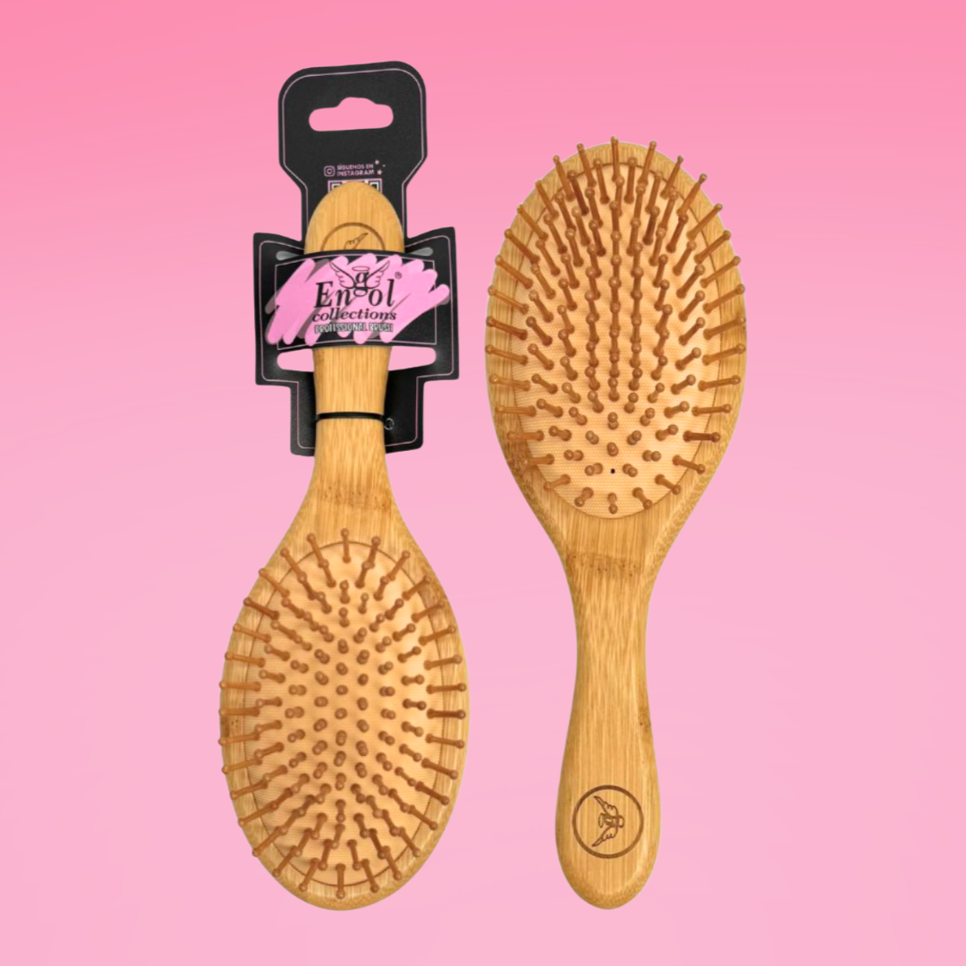 Two wooden hairbrushes on a pink background