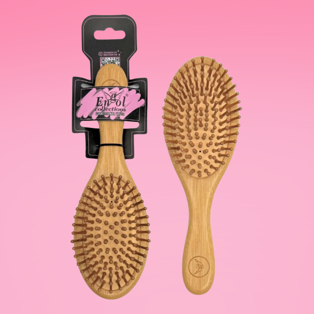Two wooden hairbrushes on a pink background