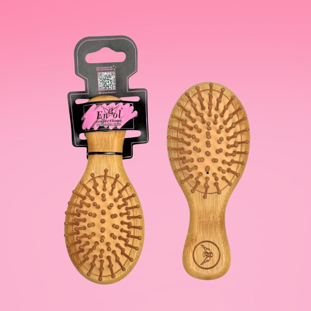Two wooden hairbrushes on a pink background